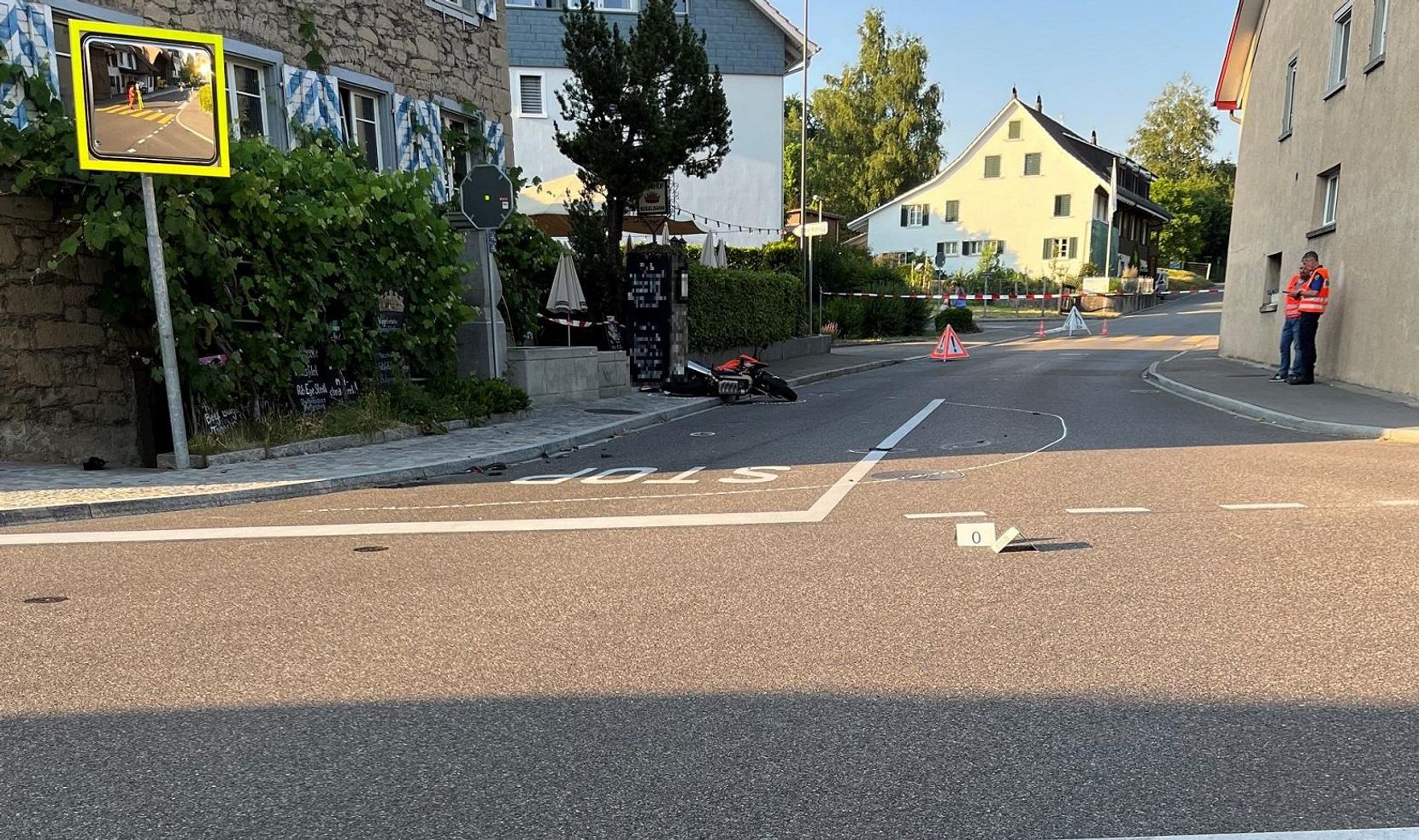 Ein Motorrad liegt nach einem Unfall auf einer Kreuzung auf der Strasse.