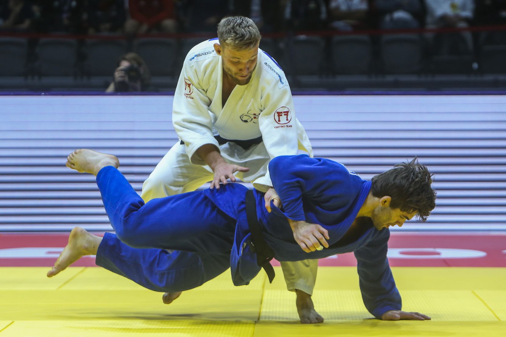 Nils Stump of Switzerland, in white, and Manuel Lombardo of Italy, compete during their Men's -73kg final medal judo match at the World Judo Championships in Doha, Qatar , Tuesday, May 9, 2023. (AP Photo/Hussein Sayed)
