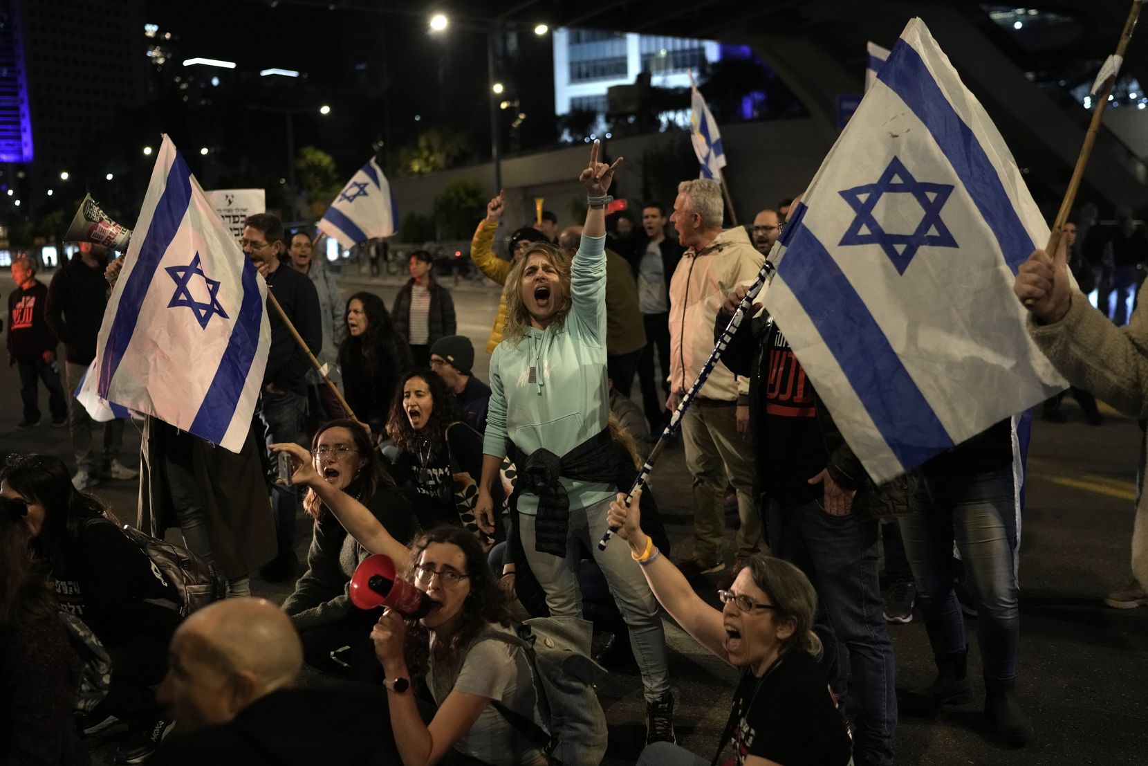 Menschen demonstrieren mit Israel-Flaggen.
